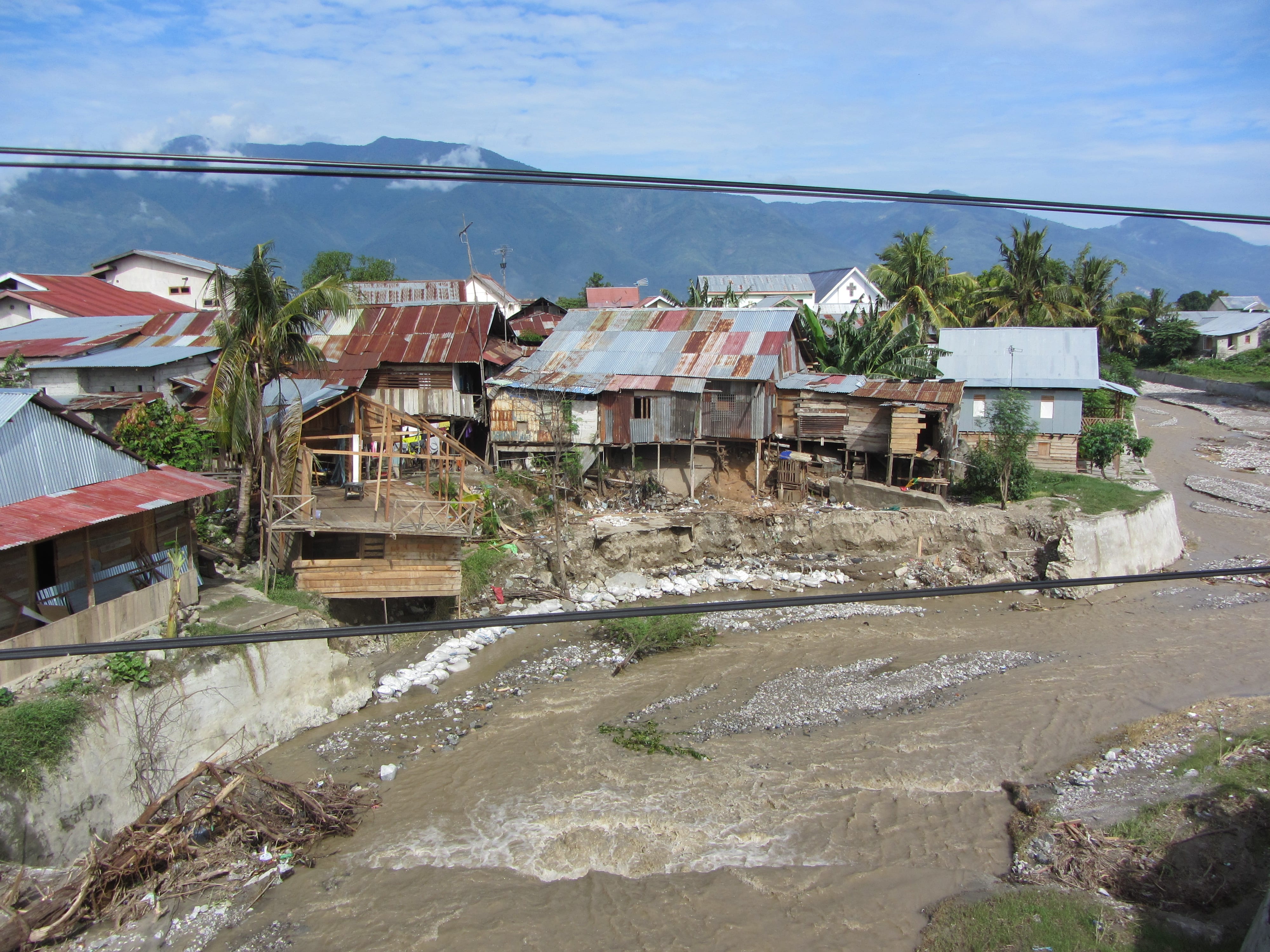 Houses in Palu being undermined by river flooding and scouring.